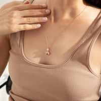 Collier photo Élégance Éternelle or rose porté sur un débardeur beige